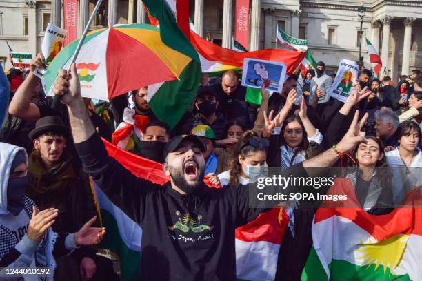 Protesters hold Iranian flags while chanting slogans in Trafalgar Square as protests for Mahsa Amini and freedom in Iran continue. Hundreds of people...