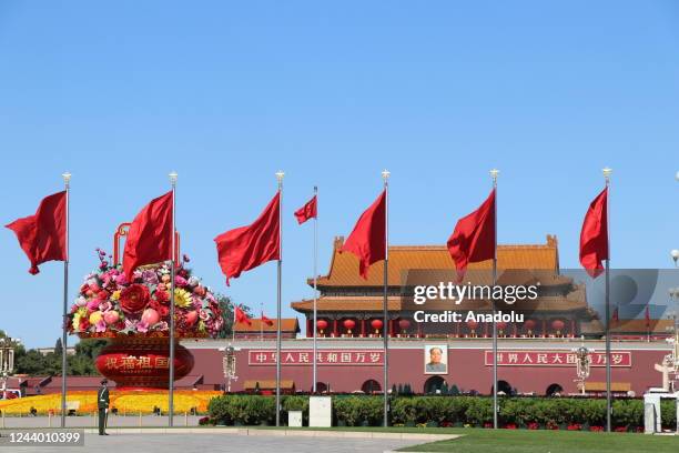 Giant flower bouquet and red flags are seen at the Tienanmen Square during the 20th National Congress of the Communist Party in Beijing, China on...