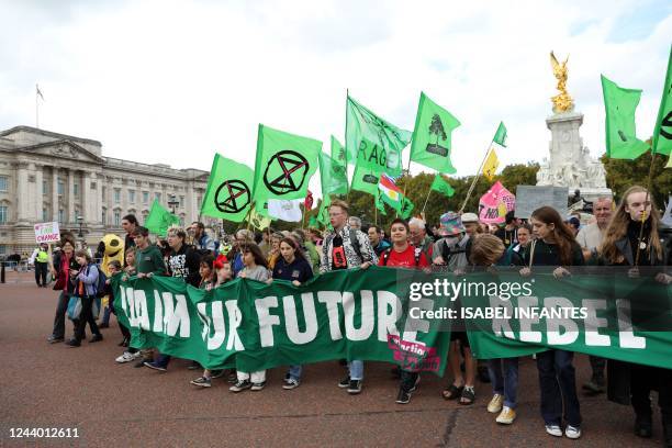 Protesters march past Buckingham Palace, into central London at a demonstration by the climate change protest group Extinction Rebellion, on October...