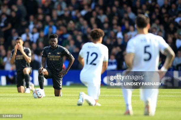 Arsenal's Ghanaian midfielder Thomas Partey takes a knee in support of the Premier League's No Room For Racism campaign ahead of the English Premier...