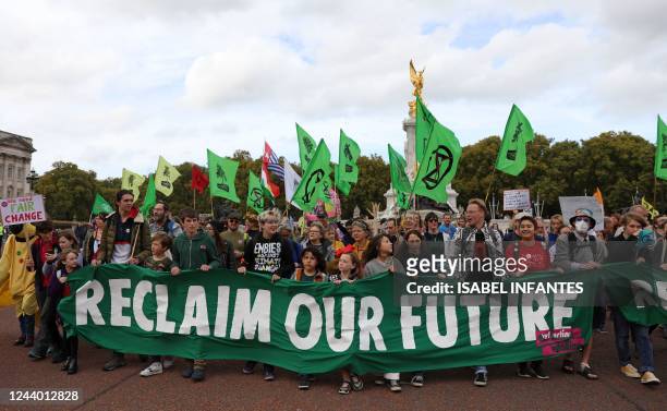 Protesters march past Buckingham Palace, into central London at a demonstration by the climate change protest group Extinction Rebellion, on October...