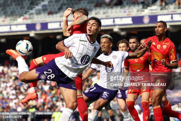 Angers' French midfielder Pierrick Capelle fights for the ball with Toulouse's French midfielder Fares Chaibi during the French L1 football match...