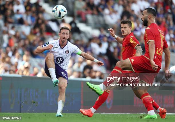 Toulouse's Belgian midfielder Brecht Dejaegere fights for the ball with Angers' French midfielder Himad Abdelli and Angers' French midfielder...