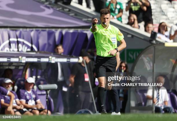 French referee Benoit Bastien decides a penalty kick after consulting the VAR during the French L1 football match between Toulouse FC and SCO Angers...
