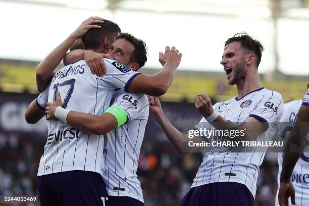 Toulouse's Dutch midfielder Stijn Spierings celebrates with teammates after he scored a goal during the French L1 football match between Toulouse FC...