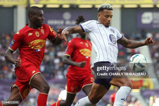 Angers' Franco-Cameroonian defender Ibrahim Amadou fights for the ball with Toulouse's Brazilian forward Rafael Ratao during the French L1 football...