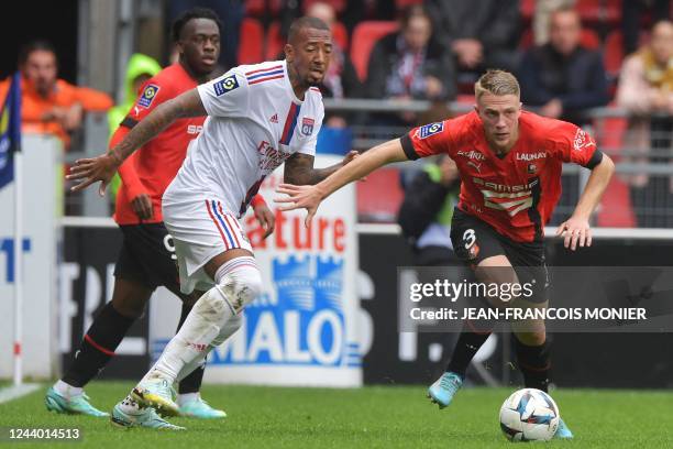 Rennes' French defender Adrien Truffert fights for the ball with Lyon's German defender Jerome Boateng during the French L1 football match between...