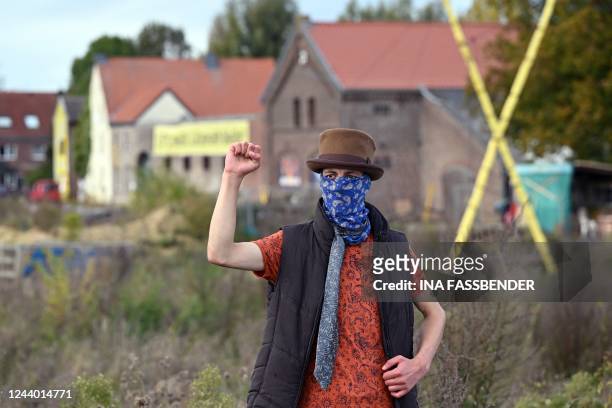 Climate activist poses at a demolished house in Luetzerath, western Germany on October 16, 2022. - German multinational energy company RWE plans to...