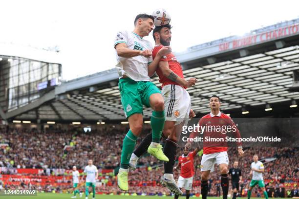 Fabian Schar of Newcastle United battles for a header with Bruno Fernandes of Manchester United during the Premier League match between Manchester...