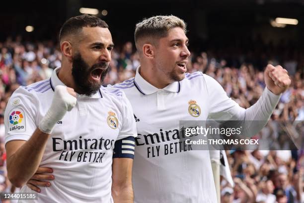 Real Madrid's French forward Karim Benzema celebrates with Real Madrid's Uruguayan midfielder Federico Valverde after scoring his team's first goal...