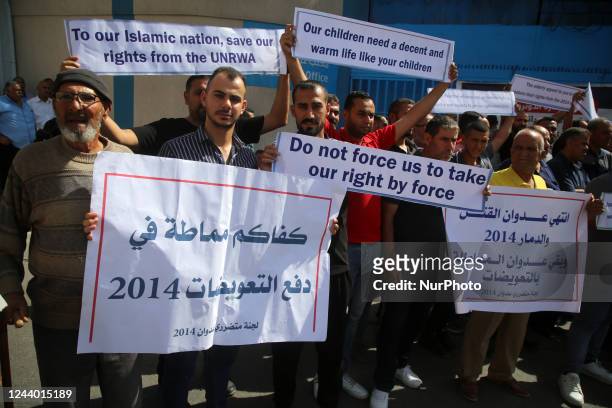 Palestinian owners of houses which were destroyed during the Israeli war of 2014, take part in a protest demanding for reconstruction of their...