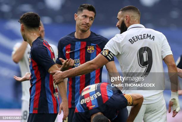 Barcelona's Spanish midfielder Pedri, and Barcelona's Polish forward Robert Lewandowski argue with Real Madrid's French forward Karim Benzema during...