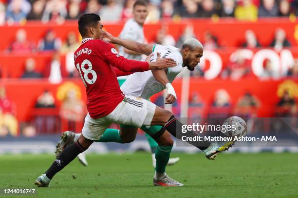 Casemiro of Manchester United and Joelinton of Newcastle United during the Premier League match between Manchester United and Newcastle United at Old...