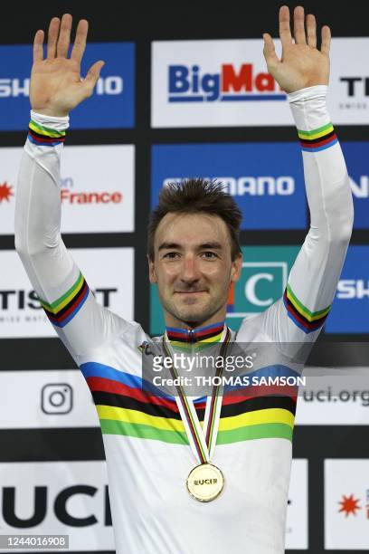 Italy's Elia Viviani celebrates his gold medal on the podium after winning the Men's Elimination finals during the UCI Track Cycling World...