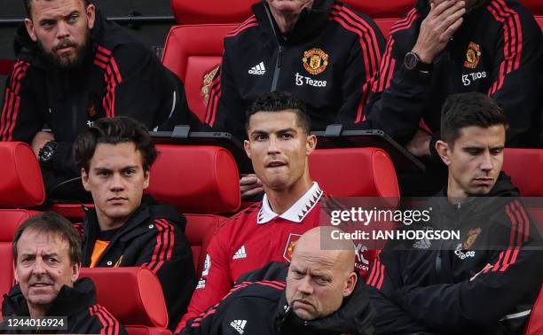 Manchester United's Portuguese striker Cristiano Ronaldo reacts as he sits on the bench during the English Premier League football match between...