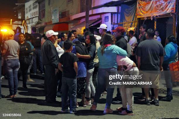 Relatives and friends react outside the bar where 12 people were killed by an armed group which opened fire on customers and staff, in Irapuato,...