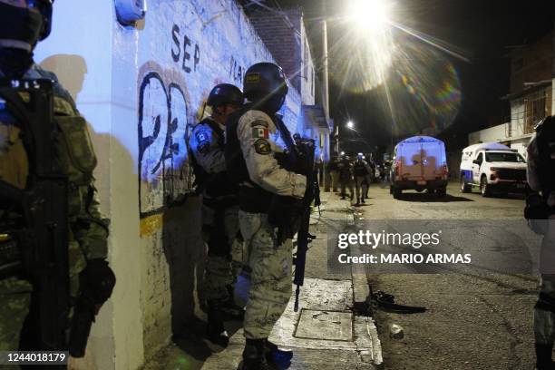 Members of the National Guard stand guard metres away from the bar where 12 people were killed by an armed group which opened fire on customers and...