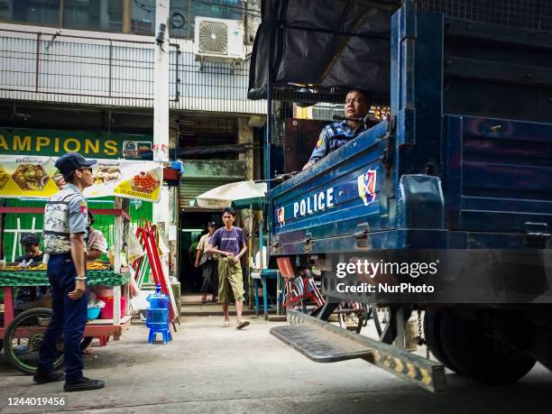 Armed police patrol on a street in Yangon, Myanmar on October 16, 2022.