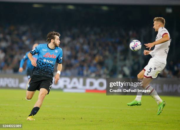 Khvicha Kvaratskhelia of SSC Napoli, Stefan Posch of Bologna FC 1909 battle for the ball during the Serie A match between SSC Napoli and Bologna FC...