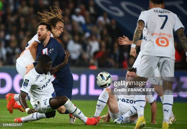 Paris Saint-Germain's Argentine forward Lionel Messi fights for the ball with Marseille's Ivorian defender Eric Bailly , Marseille's French...