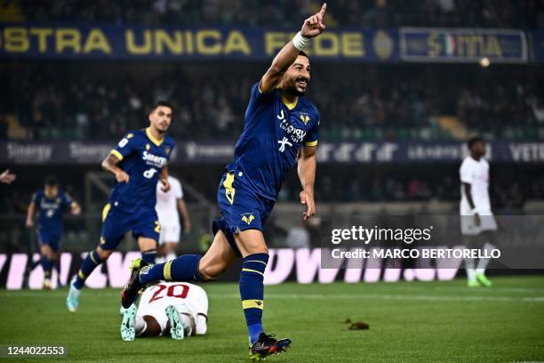 Hellas Verona's German defender Koray Guenter celebrates after AC Milan scored an own goal following his shot on target during the Italian Serie A...