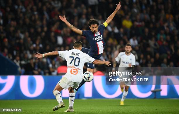 Marseille's Chilean forward Alexis Sanchez fights for the ball with Paris Saint-Germain's Brazilian defender Marquinhos during the French L1 football...
