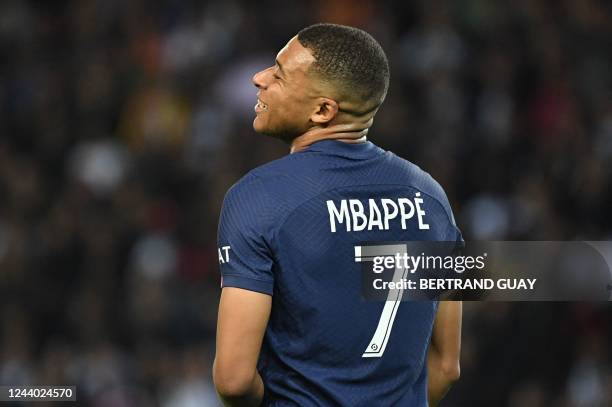 Paris Saint-Germain's French forward Kylian Mbappe reacts after missing a goal opportunity during the French L1 football match between Paris...