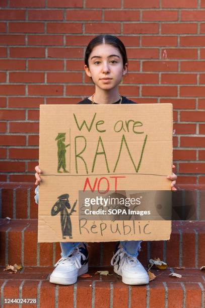 Young Iranian girl holds a placard with the inscription "We are Iran not Islamic Republic" during the demonstration. In Downtown Portland hundreds of...