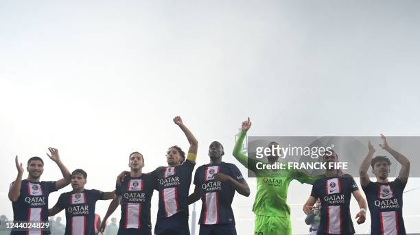 S players celebrate with supporters after winning the French L1 football match between Paris Saint-Germain and Olympique de Marseille at the Parc des...