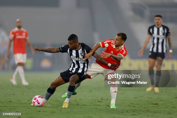 Tche Tche of Botafogo competes for the ball with Alan Patrick of Internacional during a match between Botafogo and Internacional as part of...