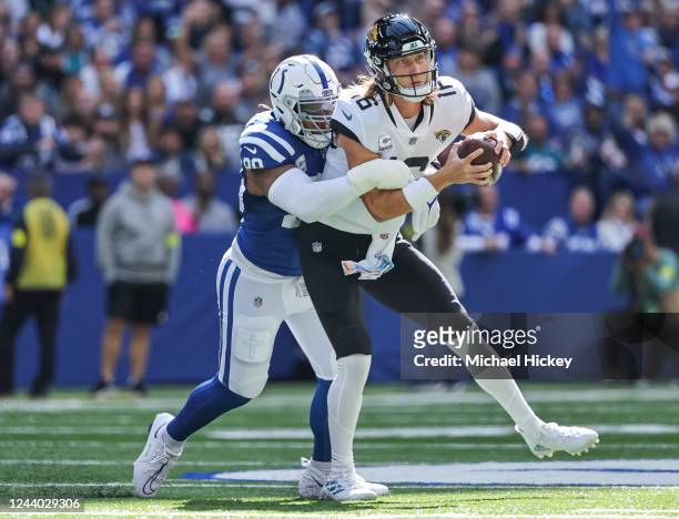 Trevor Lawrence of the Jacksonville Jaguars is sacked by DeForest Buckner of the Indianapolis Colts during the game at Lucas Oil Stadium on October...