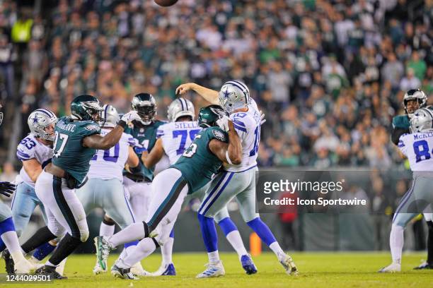 Dallas Cowboys quarterback Cooper Rush is pressured by Philadelphia Eagles defensive end Brandon Graham during the game between the Dallas Cowboys...