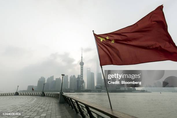 Chinese flag in front of buildings in Pudong's Lujiazui Financial District in Shanghai, China, on Monday, Oct. 17, 2022. Chinese President Xi Jinping...