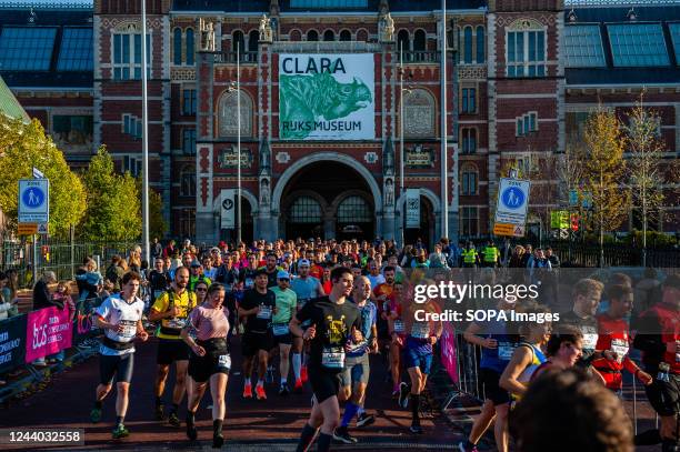 Participants crossing the famous Rijksmuseum passage during the first kilometers of the marathon. More than 18,000 runners, a record number, ran the...