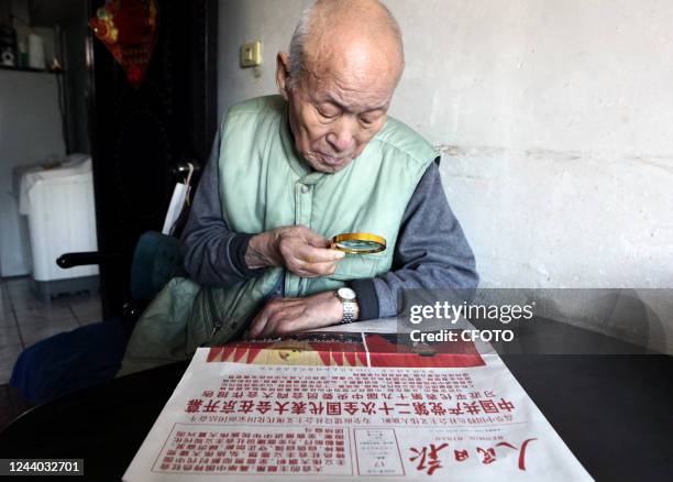 Citizen reads a newspaper to learn about the report of the 20th Communist Party of China Congress in Shenyang, Liaoning province, China, Oct 17, 2022.