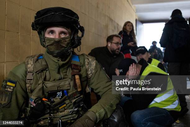 Military and rescue workers take cover in a building as Ukraine's capital is rocked by explosions during a drone attack in the early morning on...