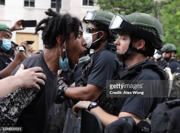 Demonstrator shouts a law enforcement officer during a peaceful protest against police brutality and the death of George Floyd, on June 3, 2020 in...