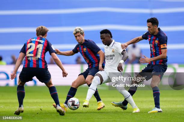 Vinicius Junior left winger of Real Madrid and Brazil surronded by Barcelona players during the La Liga Santander match between Real Madrid CF and FC...