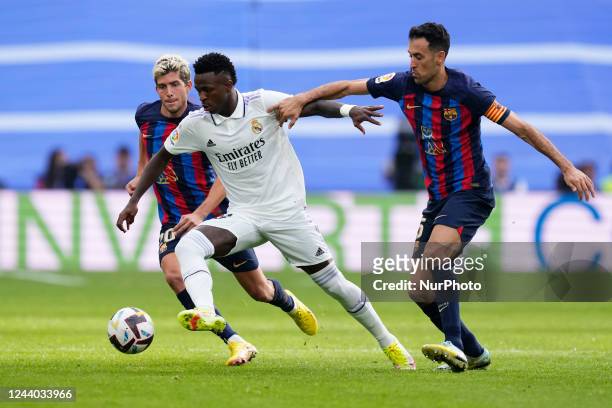 Vinicius Junior left winger of Real Madrid and Brazil surronded by Barcelona players during the La Liga Santander match between Real Madrid CF and FC...