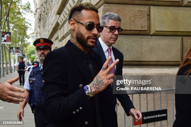 Paris Saint-Germain's Brazilian forward Neymar gestures as he leaves after attending the opening audience at the courthouse in Barcelona on October...