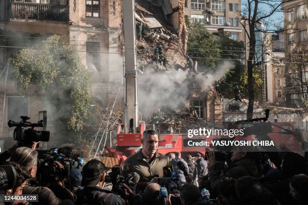 Kyiv mayor Vitali Klitschko speaks to press next to a destroyed building after a drone attack in Kyiv on October 17 amid the Russian invasion of...