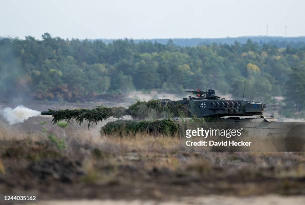 Leopard 2 main battle tank of the German armed forces fires during a demonstration for Chancellor Olaf Scholz at the Bundeswehr army training center...