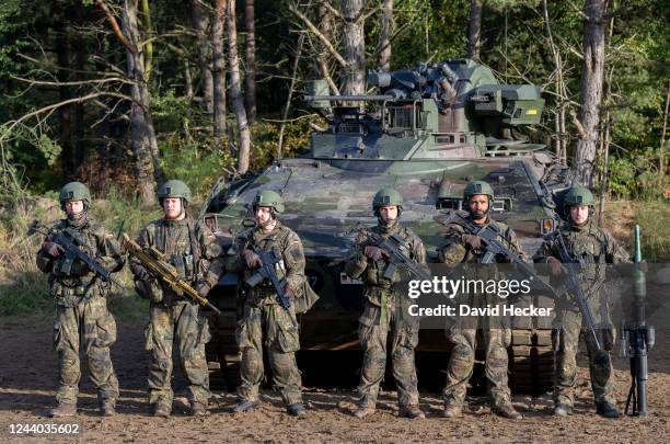 The crew of a battle tank Marder waiting for Chancellor Olaf Scholz during a visit at the Bundeswehr army training center in Ostenholz on October 17,...