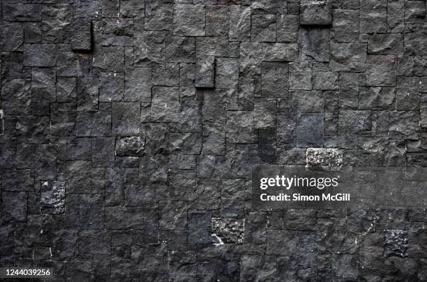 wall of grey rectangular and square stone bricks - sadness background stock pictures, royalty-free photos & images