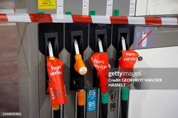 Photograph shows at a closed gas station information signs which read as "out of service" in Paris on October 17, 2022. - Emmanuel Macron called on...