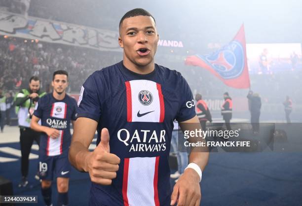 Paris Saint-Germain's French forward Kylian Mbappe gives a thumb up at the end of the French L1 football match between Paris Saint-Germain and...