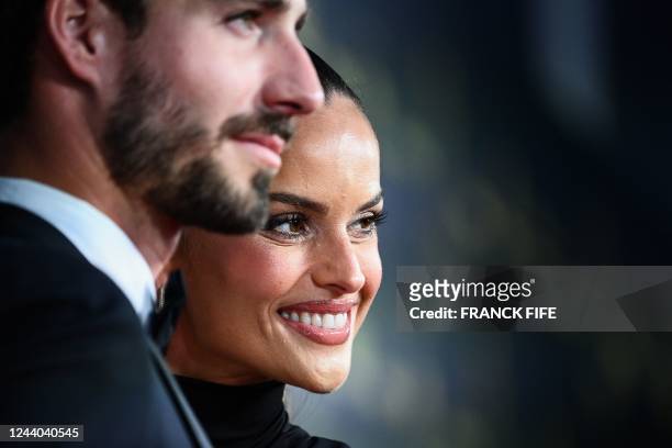 Frankfurt's German goalkeeper Kevin Trapp and his wife Brazilian model Izabel Goulard pose upon arrival to attend the 2022 Ballon d'Or France...
