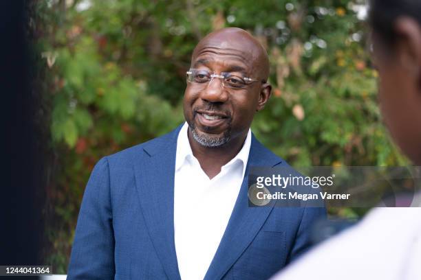Senator Raphael Warnock meets with community members to encourage them to come out and vote on the first day of early voting on October 17, 2022 in...