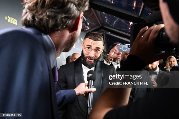 Real Madrid's French forward Karim Benzema speaks to the press upon arrival to attend the 2022 Ballon d'Or France Football award ceremony at the...