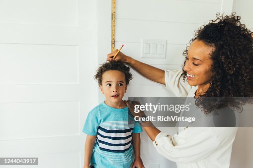 Mother Measuring Height of Son Mother Measuring Height of Son